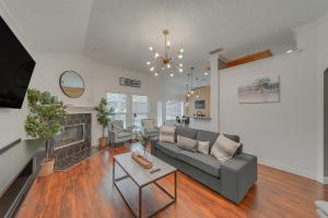a living room with a couch and a fireplace at Elegant 5BR Retreat w Private Pool & Game Room in Mesquite
