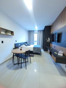 a hotel room with a bed and a table and a bedroom at Modern Studio 102 proximo Anashoping in Anápolis