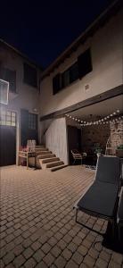 a building with a patio with chairs and a table at Chez Nadège in Marcoussis