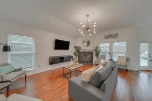 a living room with a couch and a fireplace at Elegant 5BR Retreat w Private Pool & Game Room in Mesquite
