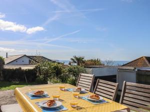 a table with two plates of food on it at Highdown in Bigbury on Sea