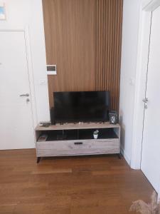 a flat screen tv on a entertainment center in a room at Aria Apartmani in Podgorica