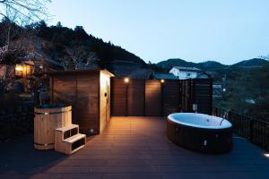 a bath tub sitting on top of a patio at Tokyo Sake House in Ome