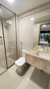 a bathroom with a toilet and a sink and a shower at Urban Stay Botanic in Goiânia