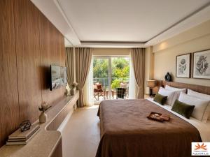 a hotel room with a large bed and a window at Aquarius Hotel in Kaş +98 photos