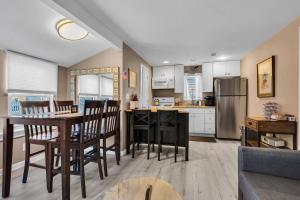 a kitchen and living room with a table and chairs at Fast Wi-Fi | Linen & Towel | Coffee | Prof Cleaned in Seaside Park
