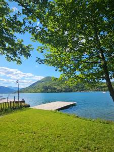 a dock on a lake with a hill in the background at Villa Pliva Lake 2 in Jajce