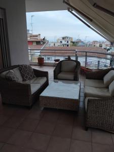 a balcony with two couches and a coffee table at Kings and Queens 2 in Larisa