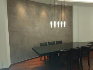 a dining room with a black table and chairs at Kings and Queens 2 in Larisa