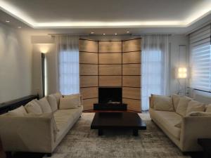 a living room with two couches and a tv at Kings and Queens 2 in Larisa