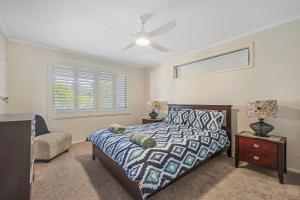 a bedroom with a bed and a ceiling fan at Francis 31 in Port Macquarie