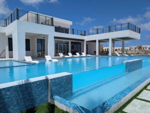 a villa with a large swimming pool with chairs at Salt & Breeze Villa in Priory