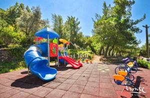 a playground with a slide and a play structure at PoolSide Residence in Kavač