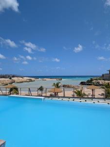 a view of the beach from the balcony of a resort at Salt & Breeze Villa in Priory