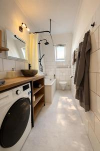 a bathroom with a sink and a washing machine at Altbau Apartment mit toller Terrasse in Mülheim an der Ruhr