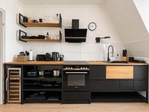 a kitchen with a black counter and a sink at Altbau Apartment mit toller Terrasse in Mülheim an der Ruhr