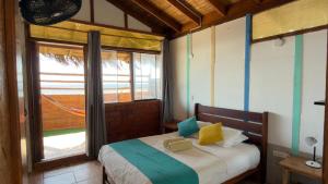 a bedroom with a bed and a large window at The Point Mancora Beach - Hostel Juvenil de Fiesta in Máncora +26 photos