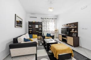 a living room with a couch and a table at Vila Palma in Berat