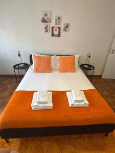 a large bed with two towels on top of it at Setúbal Sunset Apartment in Setúbal