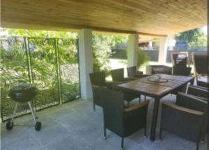a patio with a wooden table and chairs at Villa cosy in Biganos +3 photos