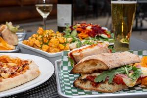 a table with plates of food and a glass of wine at Saddle Mountain Lodge in Blue River