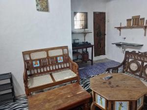 a living room with two chairs and a table at Precious Bungalow House in Lamu