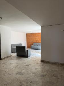 a living room with two couches and a couch at Casa a 5 min del perímetro ferial in Aguascalientes