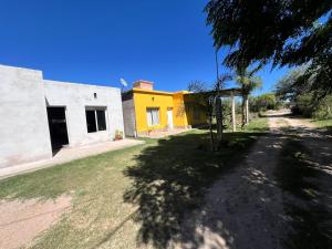 a yellow and white building on the side of a street at Casa en la Puntilla 2 in Belén