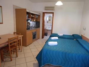 a room with a bed and a table and a kitchen at Hotel Casa Cigliano in Forio d'Ischia +36 photos