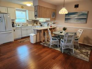 eine Küche mit Tisch, Stühlen und Kühlschrank in der Unterkunft Outer Banks in Kitty Hawk