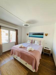 a bedroom with a large bed with two towels on it at Puerto de Pollença - Beach and Center,Happy Mar in Port de Pollensa +7 photos
