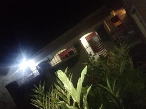 a street light in front of a building at night at Urban-den in Kampala