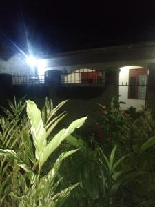 a house at night with a light on it at Urban-den in Kampala