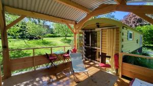 a house with a deck with a view of a yard at Graines de nature - Ecolodges Insolites in Saint-Eutrope-de-Born