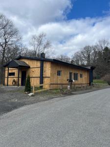 a wooden building on the side of a road at Beautiful cabin surrounded by nature in Catskill