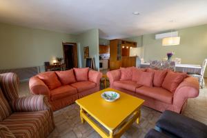 a living room with two couches and a table at Ioanna Sunset Retreat in Chalkida