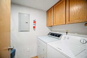 a kitchen with a washer and a fire extinguisher at 28 Quelah Condo in Sunriver