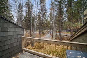 a balcony with a view of the woods at 28 Quelah Condo in Sunriver