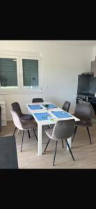 a dining room with a white table and chairs at Rados Villa Flora in Fažana +2 photos