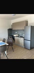 a kitchen with a refrigerator and a table and chairs at Rados Villa Flora in Fažana