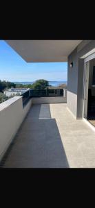 a balcony of a house with a view of the water at Rados Villa Flora in Fažana