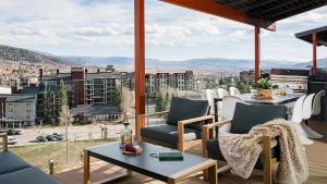 a patio with a table and chairs and a view of a city at Allegro Peak in Steamboat Springs