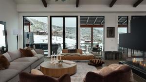 a living room with couches and a large fireplace at Allegro Peak in Steamboat Springs