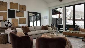 a living room with a couch and chairs at Allegro Peak in Steamboat Springs