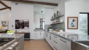 a large kitchen with white cabinets and a counter top at Allegro Peak in Steamboat Springs