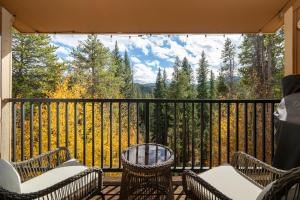 a balcony with chairs and a view of the mountains at Beaver Village Unit #2031 in Winter Park
