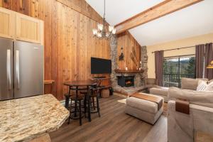 a kitchen and living room with wood paneling at Beaver Village Unit #2031 in Winter Park +23 photos