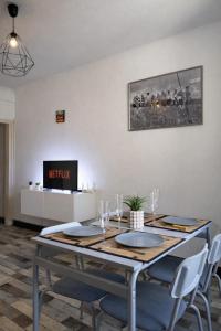 a dining room with a table with chairs and a tv at Le Royal Colbert - Hyper Centre - Cozy & Elegant in Tours