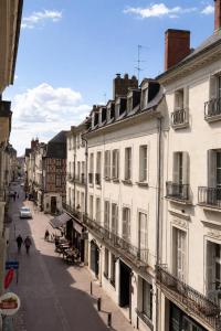 a city street with buildings and people walking down a street at Le Royal Colbert - Hyper Centre - Cozy & Elegant in Tours