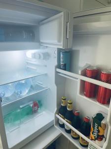 an open refrigerator filled with lots of bottles of soda at SoverHouse affittacamere a Soverato Marina in Soverato Marina